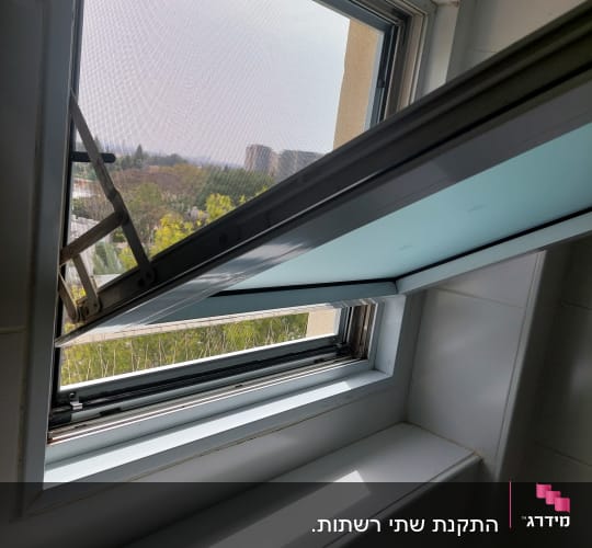 חלון אלומיניום פתוח עם מסגרת מתכת